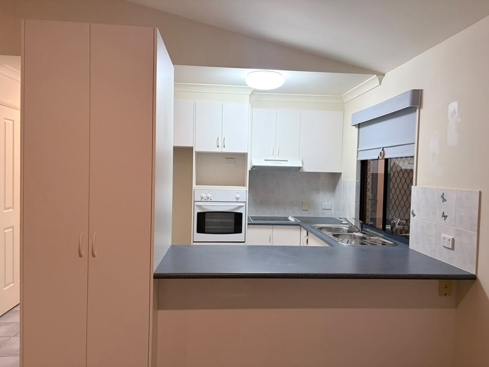 Kitchen photograph shared by PrimeNest, with white cabinetry and clear benchtops